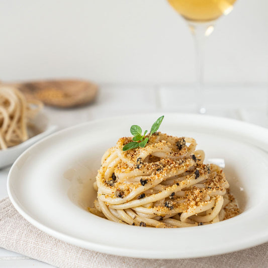 Pici pasta with truffles, breadcrumbs and anchovies 